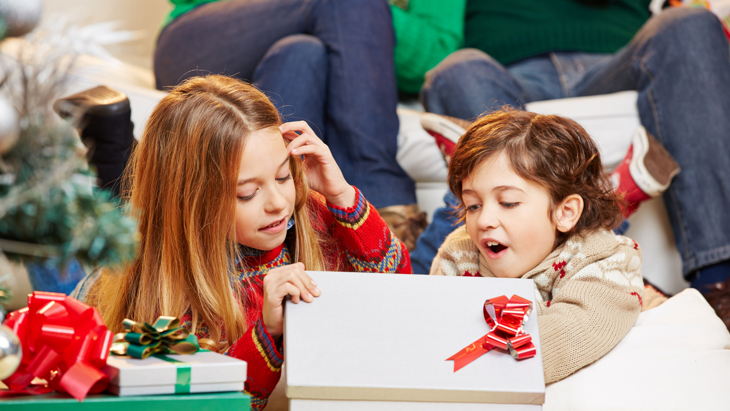 Children opening up christmas presents together
