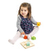 little girl playing with audio sensory tray